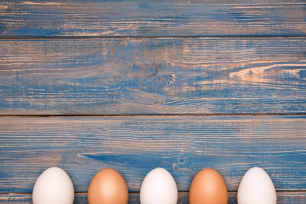 Eggs frame on wooden background