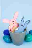 Foto gratuita le uova si avvicinano ai conigli del giocattolo in tazza
