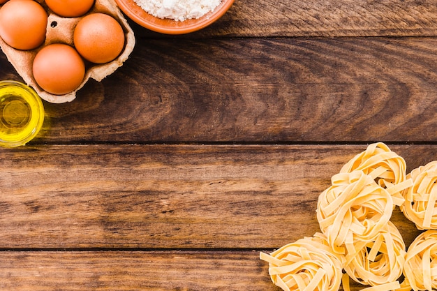 Eggs and oil near pasta