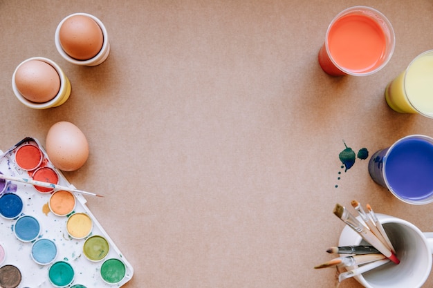 Eggs and palette of colors on table