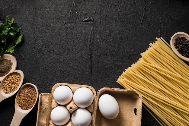 Eggs and pasta near spices