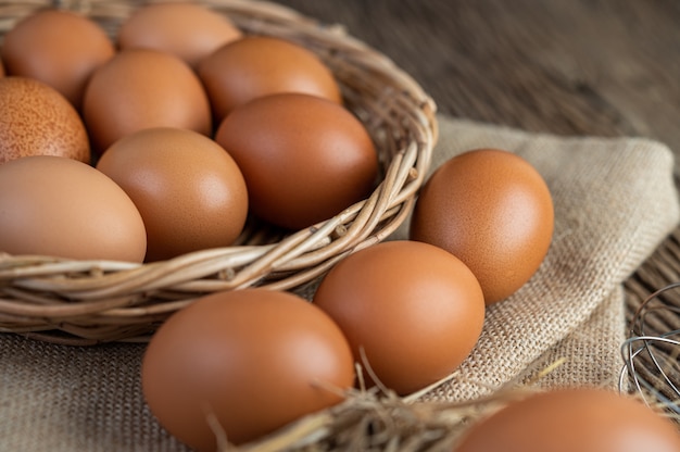 Free photo eggs on the sacks, hemp on the wooden and straw