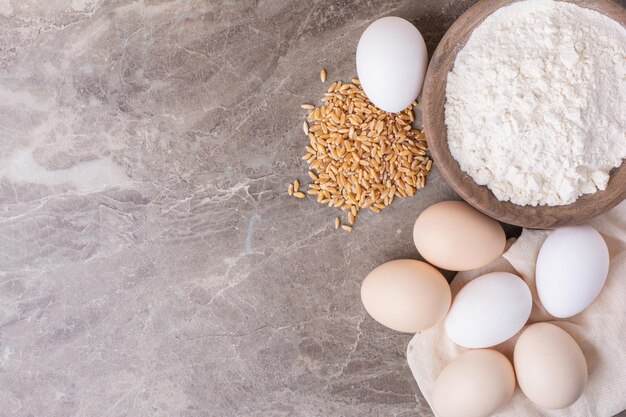 Eggs in a white cup on grey table.