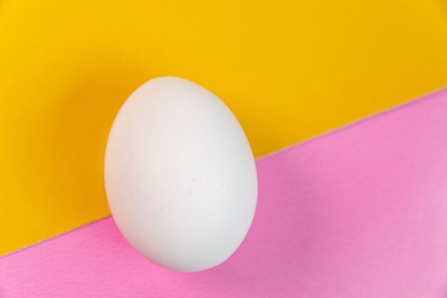Eggs on the yellow and pink background