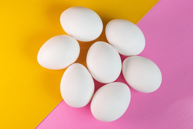 Eggs on the yellow and pink background