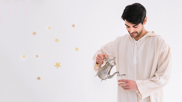 Eid al-fitr concept with man making tea