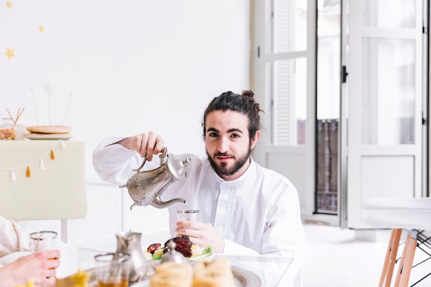 Eid al-fitr concept with man and tea