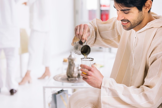 Eid al-fitr concept with man and tea