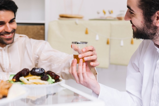 Free photo eid al-fitr concept with tea glass and dates