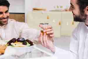 Free photo eid al-fitr concept with tea glass and dates