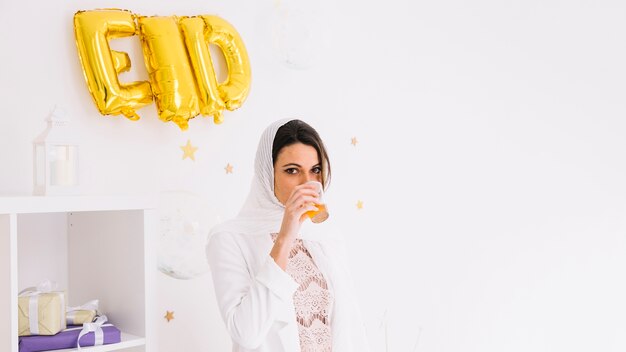 Eid concept with woman drinking