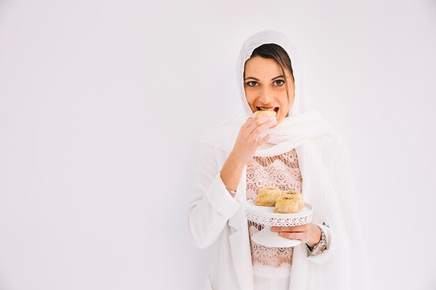 Eid concept with woman holding arab pastry