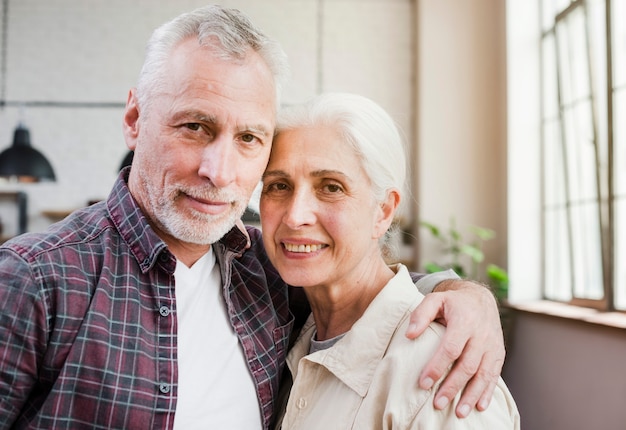 Elder couple posing for a photo