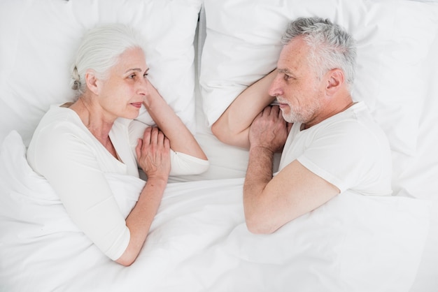 Free photo elder couple resting in the bed