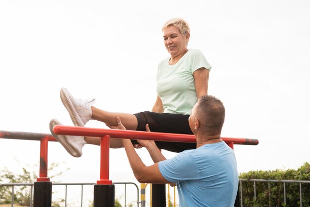 Elder couple working out together outdoors in the park