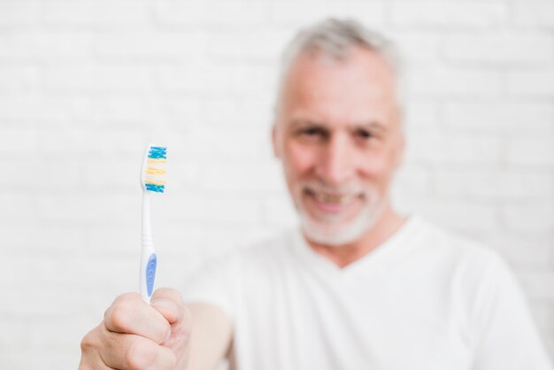 Elder man washing his teeth