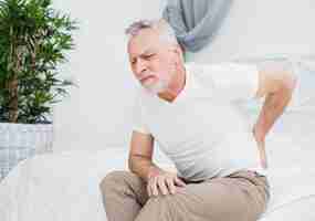 Free photo elder man with back pain