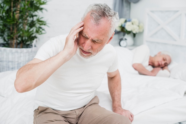 Free photo elder man with a headache