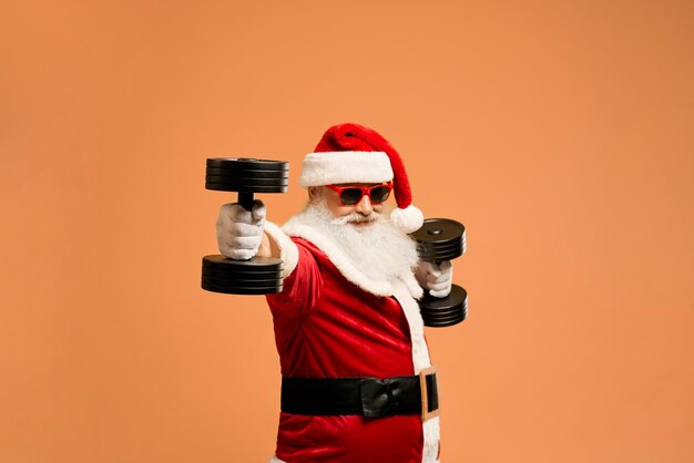 Elder saint nicholas in sunglasses exercising with dumbbells