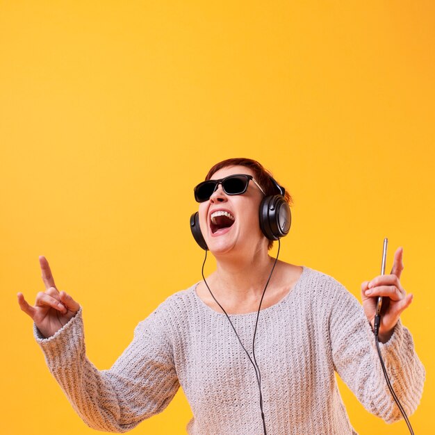 elder woman listening rock music