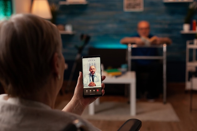 elder woman with disability using video call for telemedicine