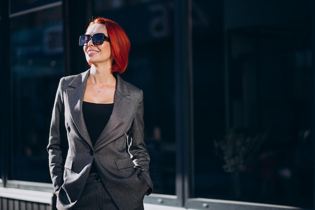 Elderly business woman in grey suit outdoors