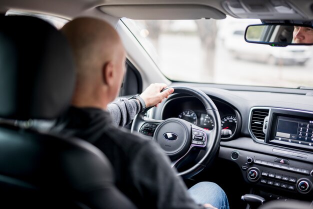 Elderly businessman driving 