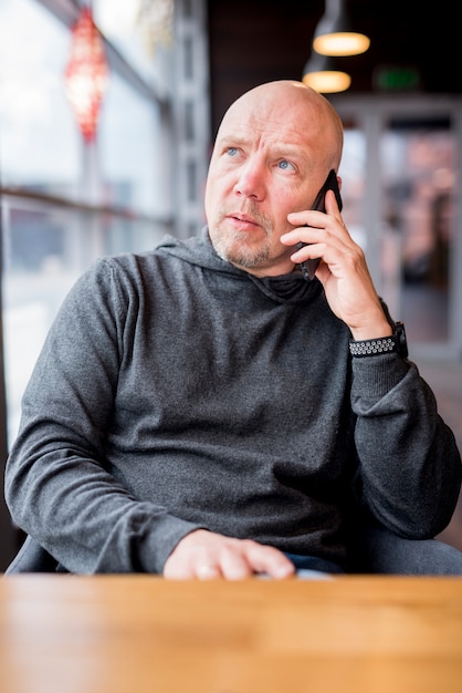 Elderly businessman talking by telephone