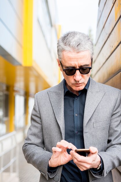 Elderly businessman using mobile phone