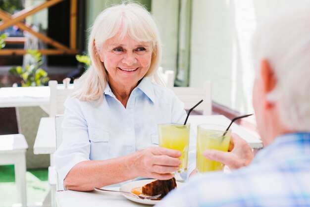 Elderly couple clinking with glasses