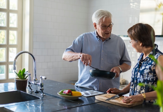 Elderly couple cooking together