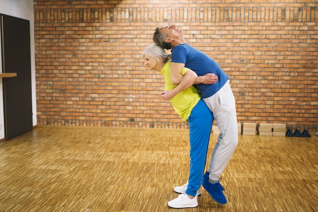 Elderly couple in fitness studio