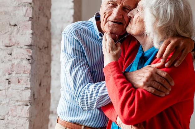 Elderly couple hugging each other