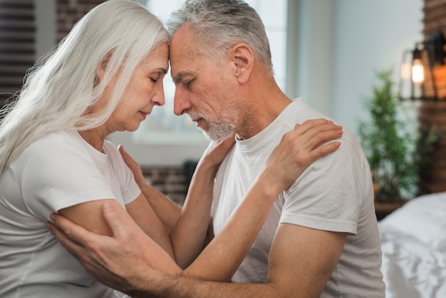 Elderly couple looking at each other