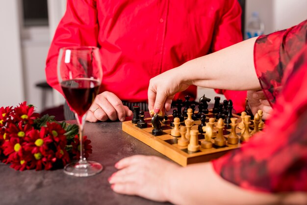 Elderly couple playing chess