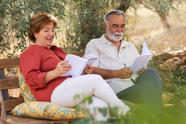 Elderly couple reading together at their countryside home