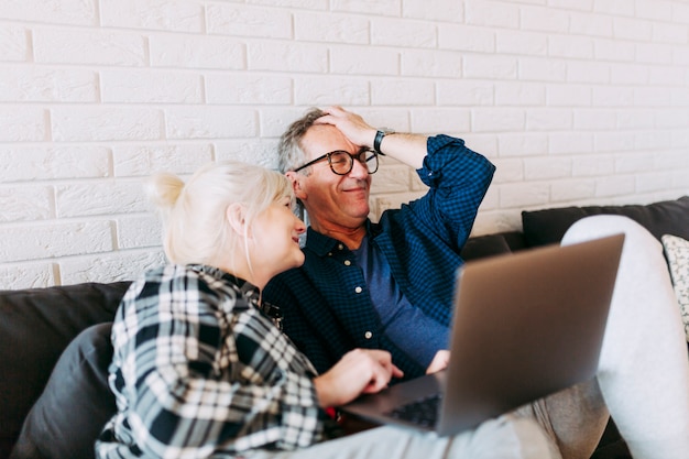 Elderly couple in retirement home with laptop