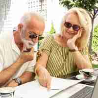 Free photo elderly couple taking  notes on  the agenda