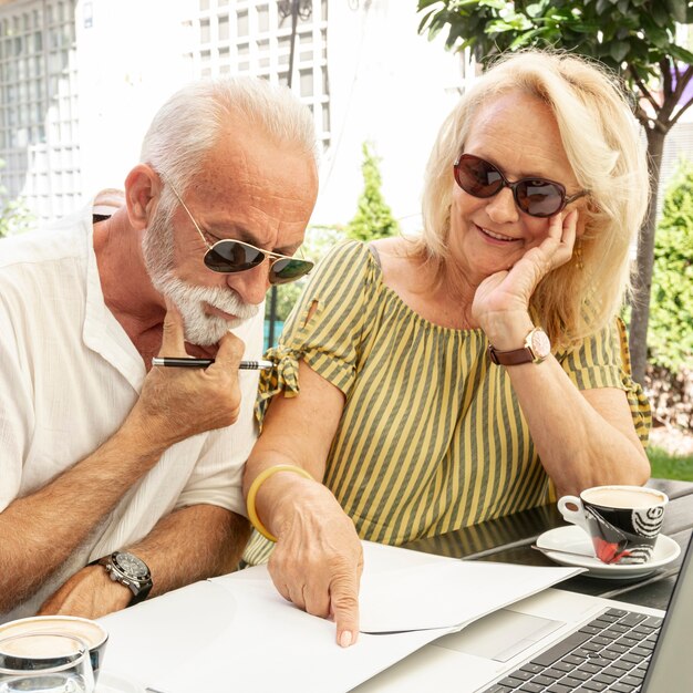elderly couple taking  notes on  the agenda