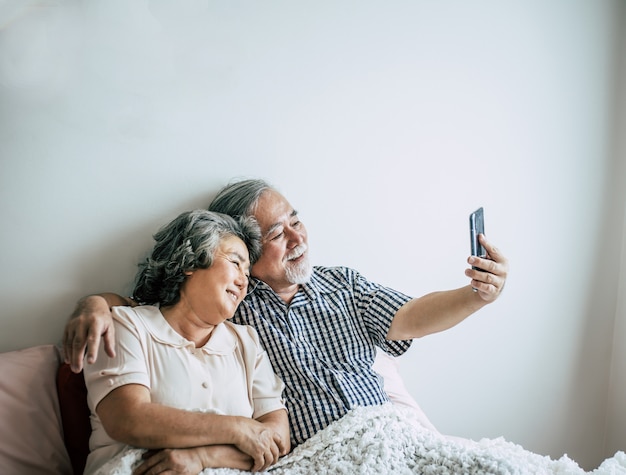 Elderly Couple Using Smartphone