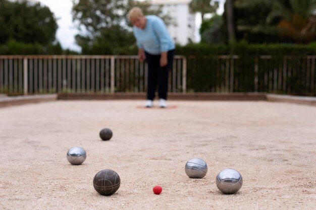 Elderly friends playing petanque