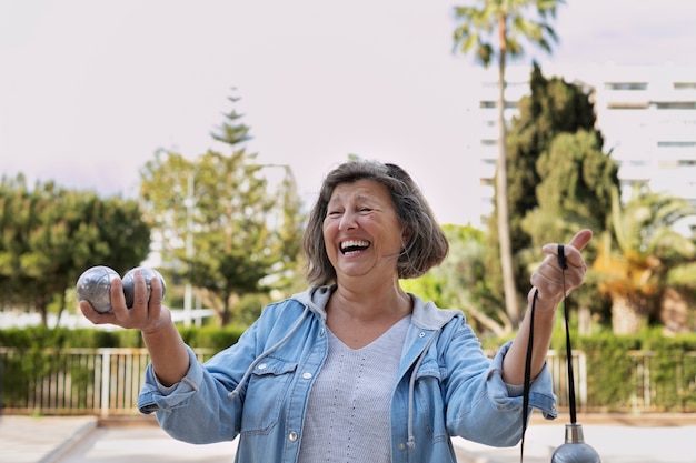 Elderly friends playing petanque