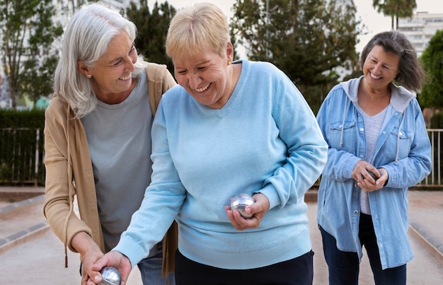 Free photo elderly friends playing petanque