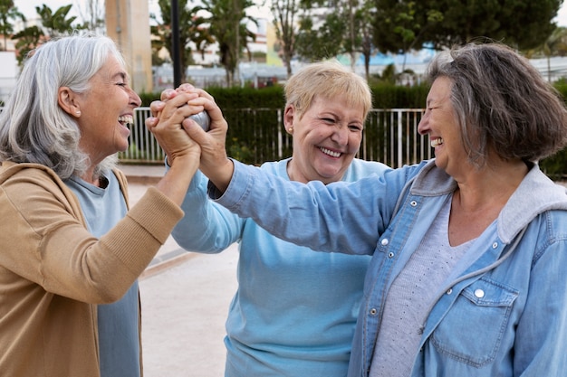 Elderly friends playing petanque