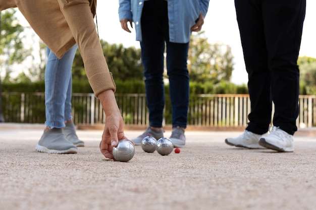 Free photo elderly friends playing petanque