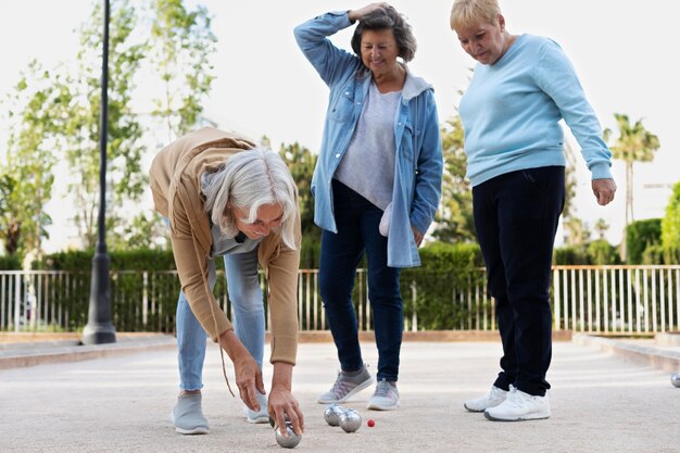 Elderly friends playing petanque