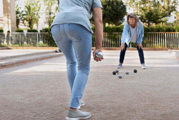 Elderly friends playing petanque