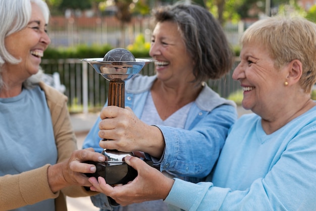 Free photo elderly friends playing petanque