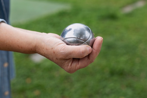 Free photo elderly friends playing petanque