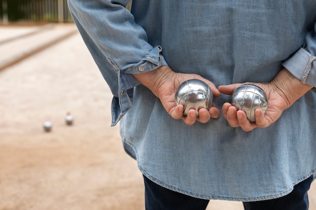 Elderly friends playing petanque